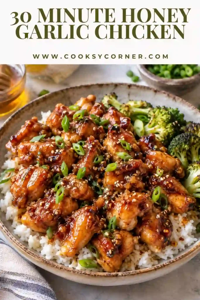 Sheet pan chicken and broccoli coated in a sticky sauce made with honey, fresh garlic, soy sauce, lemon, and sesame oil. The golden chicken is finished with sesame seeds and green onions.