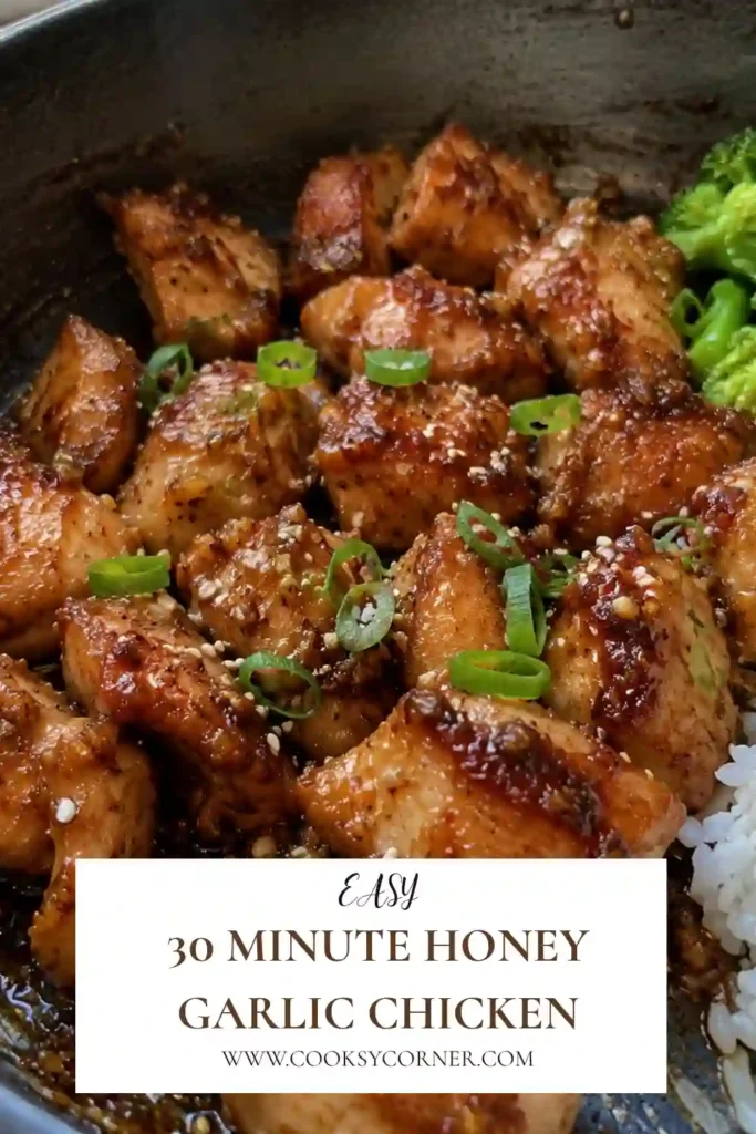 30 Minute Honey Garlic Chicken with golden chicken pieces coated in sticky honey garlic and gochujang sauce. Roasted broccoli, green onions, and toasted sesame seeds complete the colorful sheet-pan dinner.