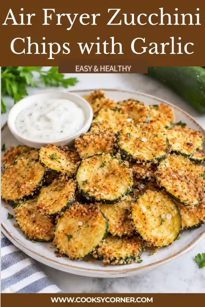 Air fried zucchini slices resting on a wire cooling rack after cooking. The thin rounds are golden at the edges and spaced apart to release steam.