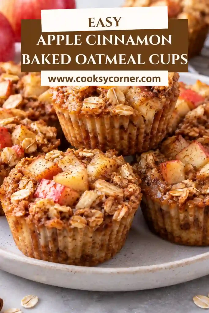 Apple cinnamon oatmeal cups arranged for breakfast with fresh apple slices and a drizzle of maple syrup. The baked oatmeal has a soft, hearty texture with golden edges and cozy spices.