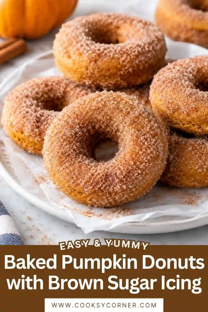 Homemade baked pumpkin donuts arranged on a cooling rack with glossy brown sugar icing. Chopped walnuts add texture to the soft pumpkin spice donuts.