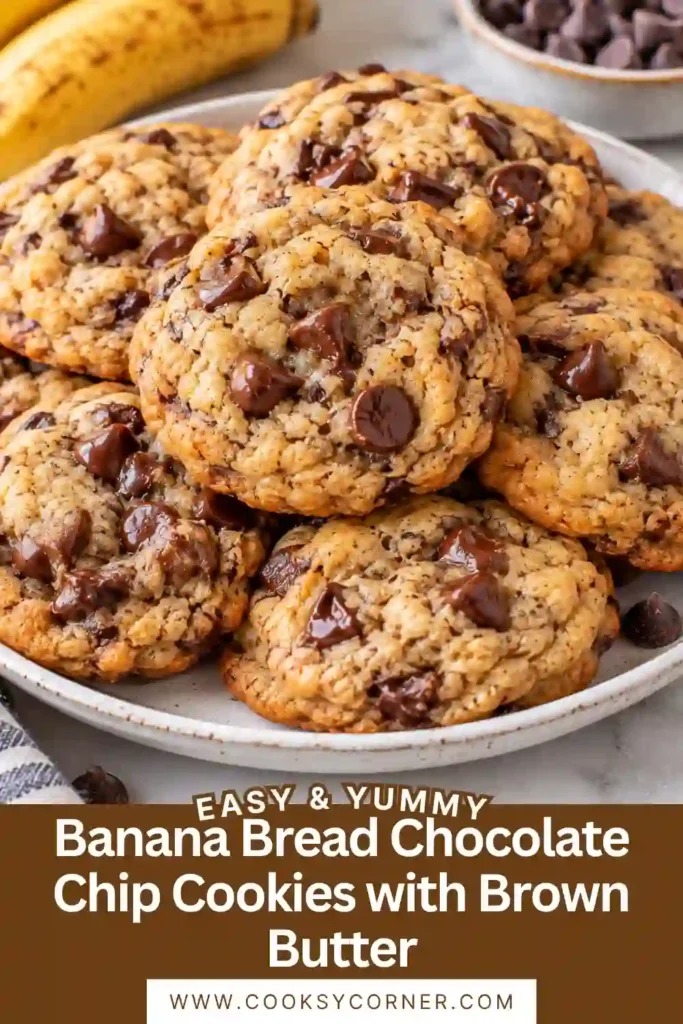 A banana chocolate chip cookie broken in half to reveal a tender center and melted chocolate. The browned edges and soft interior show the cookie’s chewy texture.