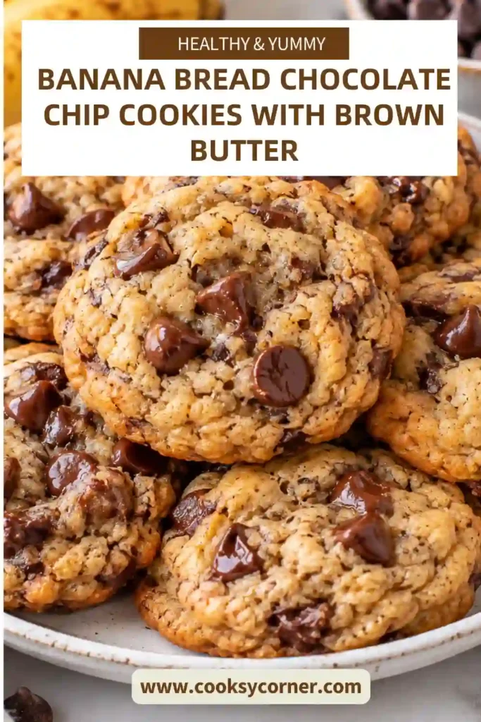 Banana bread chocolate chip cookies stacked on a plate with golden edges and visible chocolate chips. The cookies have soft-looking centers and a light sprinkle of flaky sea salt.