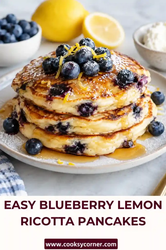 Fluffy Blueberry Lemon Ricotta Pancakes stacked on a plate with juicy blueberries and fresh lemon. Brown butter gives the golden pancakes a rich, nutty flavor.