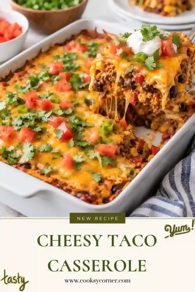 Homemade Taco Casserole topped with melted Cheddar cheese, chopped tomatoes, green onions, and sliced black olives. This tortilla chip casserole features hearty layers of seasoned beef, beans, sour cream, and crunchy corn chips.