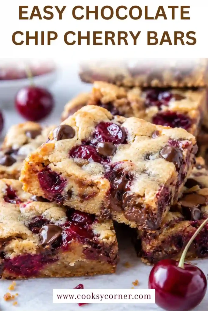 Chocolate Chip Cherry Bars with soft blondie centers, juicy red cherries, and melted semi-sweet chocolate chips. The baked bars have lightly golden edges and visible pockets of fruit and chocolate.