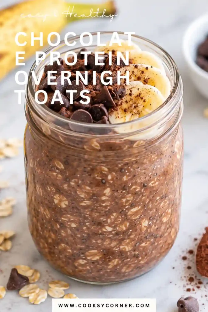 Chocolate protein overnight oats in a glass jar with a thick, creamy cocoa-colored texture. The oats are ready to eat after chilling overnight.