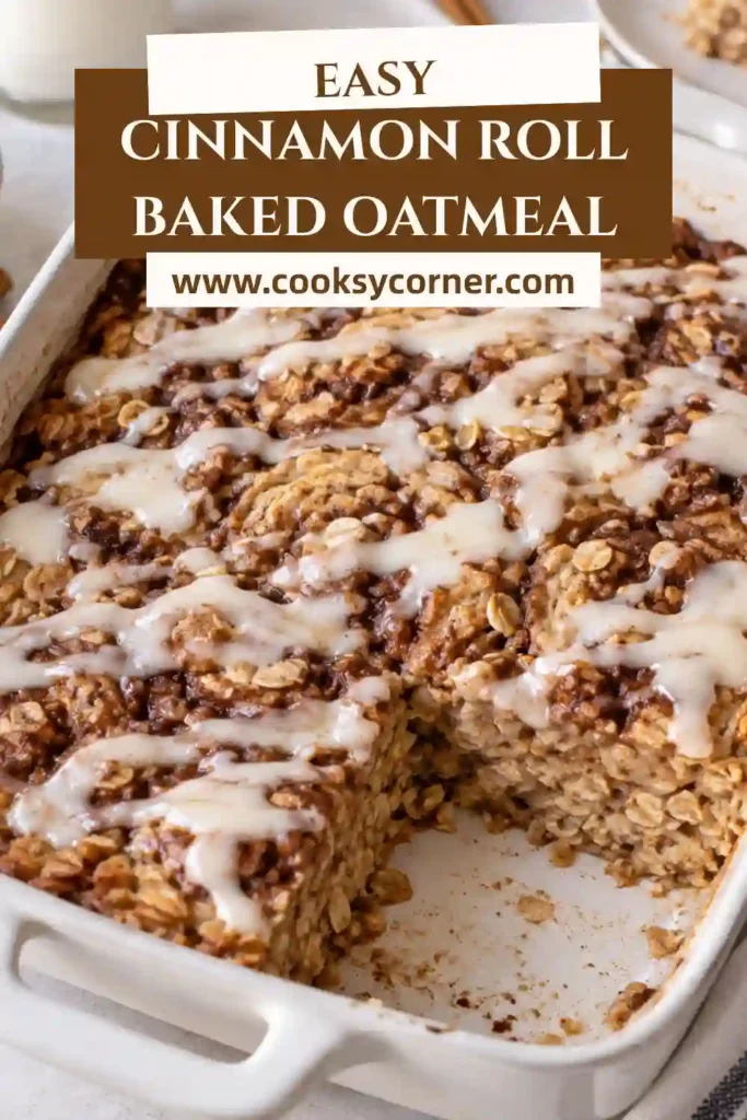 Cinnamon Roll Baked Oatmeal featuring golden edges, soft oatmeal, and a generous drizzle of white vanilla glaze. The cinnamon sugar swirl creates a beautiful cinnamon roll-inspired appearance.