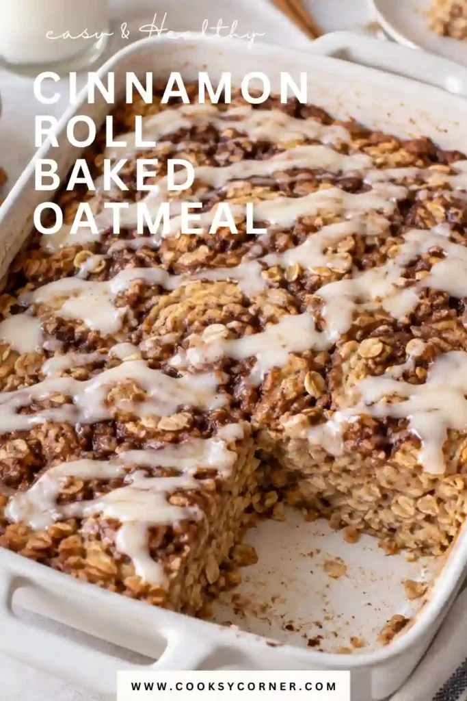 Cinnamon Roll Baked Oatmeal topped with a sweet vanilla glaze and visible cinnamon sugar swirls. The golden baked oats are sliced into squares and served in a ceramic baking dish.