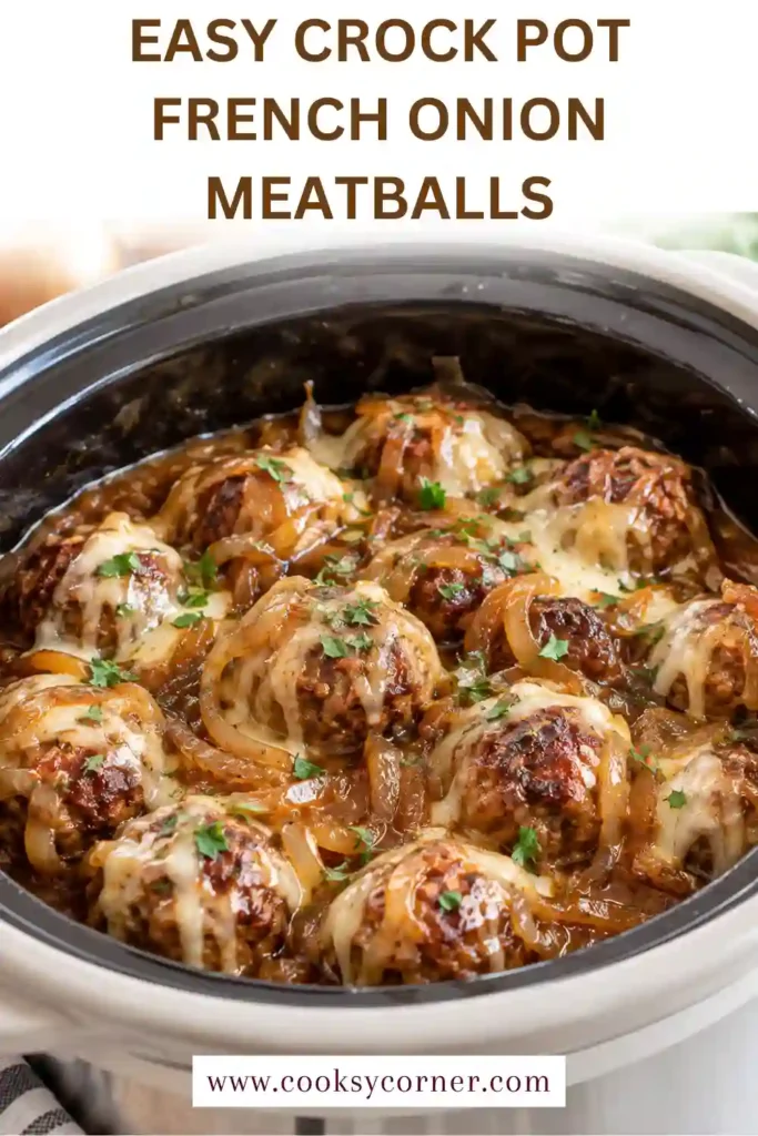 Close-up of cheesy French onion meatballs with melted Gruyère-style cheese and thick brown gravy. Tender onions are visible around the beef meatballs.