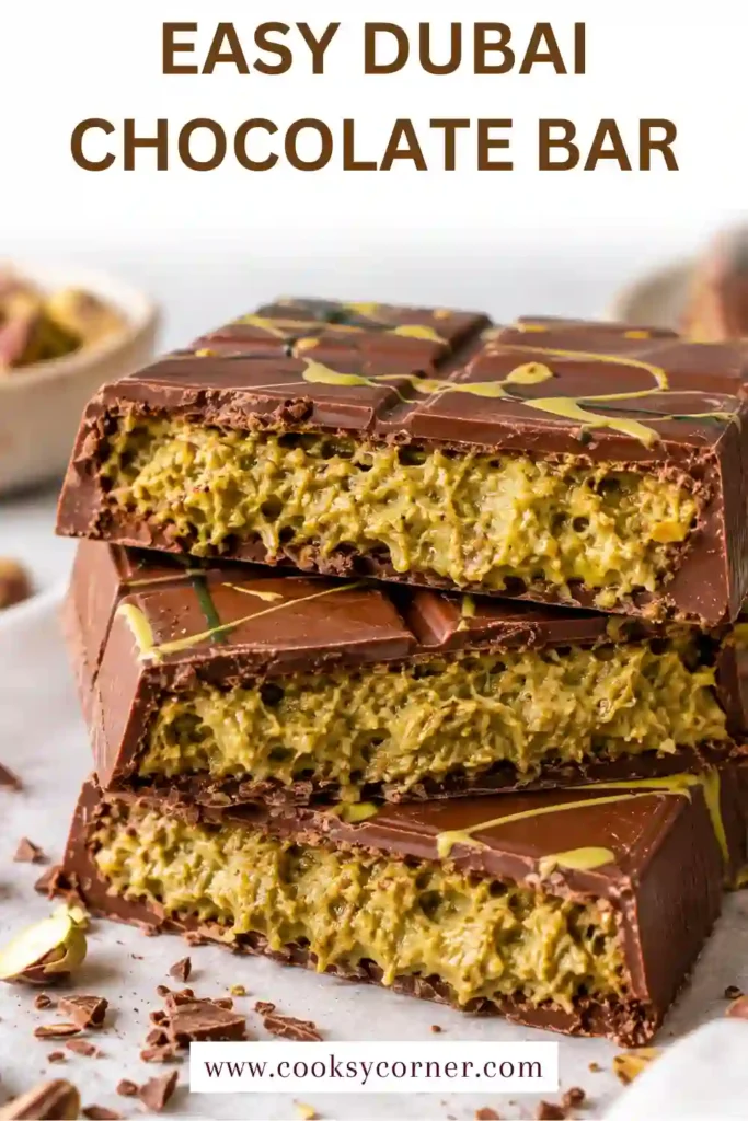 Sliced pistachio chocolate bar showing layers of smooth milk chocolate and crunchy pistachio kataifi filling. This viral Dubai chocolate combines pistachio cream, tahini, and toasted pastry in every piece.