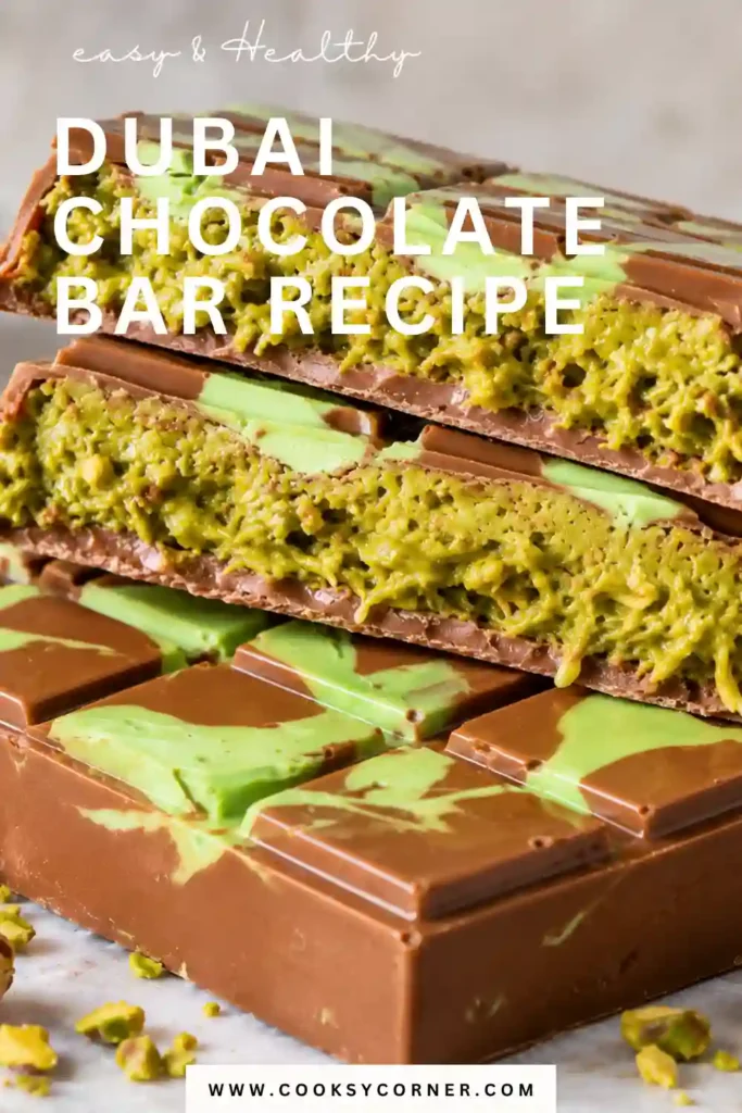 Dubai pistachio chocolate broken open to reveal crispy kataifi and creamy pistachio filling. Smooth milk chocolate creates a glossy shell around the crunchy Middle Eastern-inspired center.