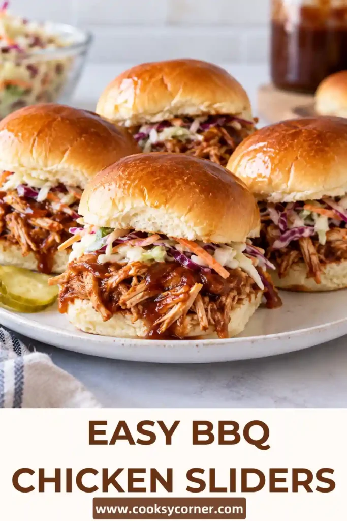Cheesy chicken sliders layered with BBQ chicken, mozzarella, smoked Gouda and red onion inside golden baked buns. The warm sliders have a gooey cheese filling and buttery tops.