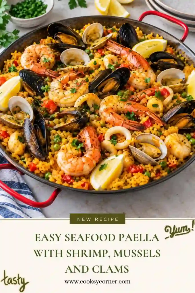 Spanish-inspired seafood rice topped with shrimp, mussels, clams, white fish, and fresh lemon wedges. The rice is cooked with tomato, garlic, herbs, and smoked paprika.