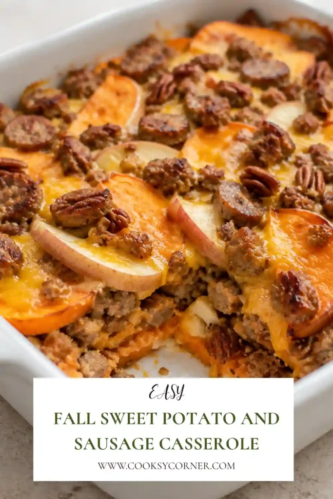 Sweet potato sausage casserole featuring orange sweet potato slices, savory beef sausage, baked apples, pecans, and bubbling cheddar cheese. The colorful layered casserole makes a hearty fall dinner.