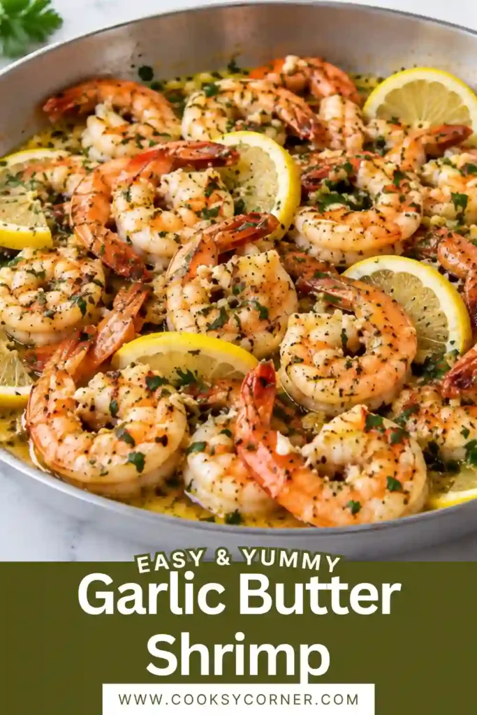 Juicy Garlic Butter Shrimp served with lemon wedges and fresh parsley in a skillet. The tender shrimp are coated with a rich buttery garlic sauce and flecks of herbs.