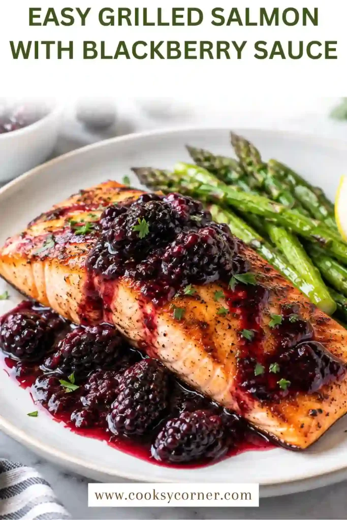 Grilled salmon fillet with a glossy blackberry sauce, fresh blackberries, and green vegetables. Chili garlic seasoning gives the salmon a savory, lightly spicy grilled finish.