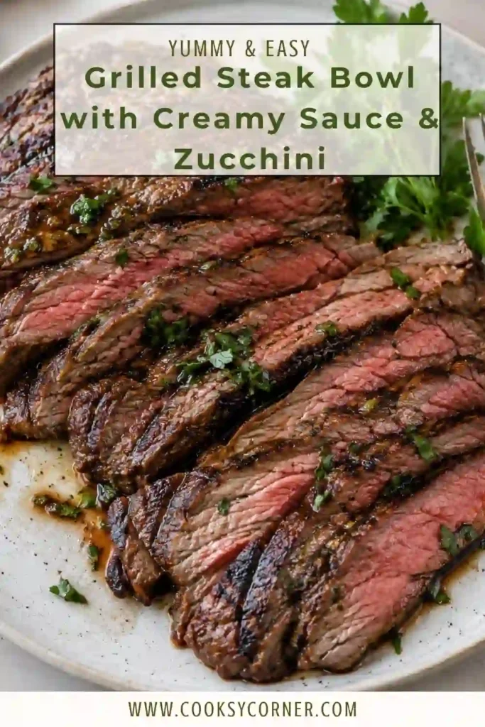 Healthy steak bowl featuring seasoned grilled beef, quinoa, and golden grilled zucchini. The bowl is finished with a creamy garlic sauce for an easy high protein dinner.