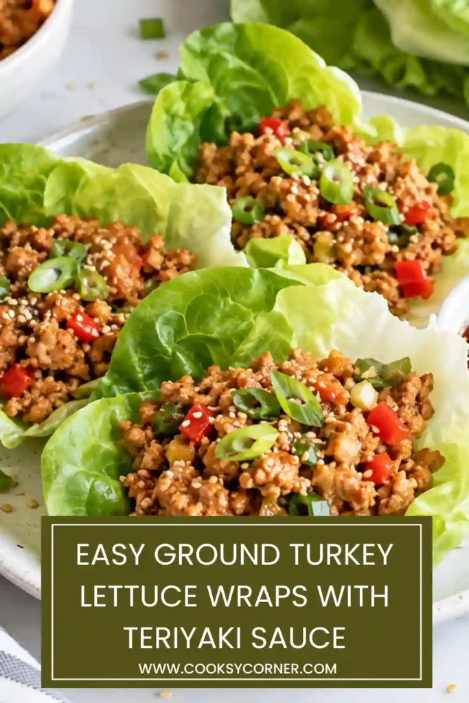Platter of ground turkey lettuce wraps arranged with cucumber matchsticks, carrots, and green onions. Each lettuce cup contains a portion of warm teriyaki turkey.