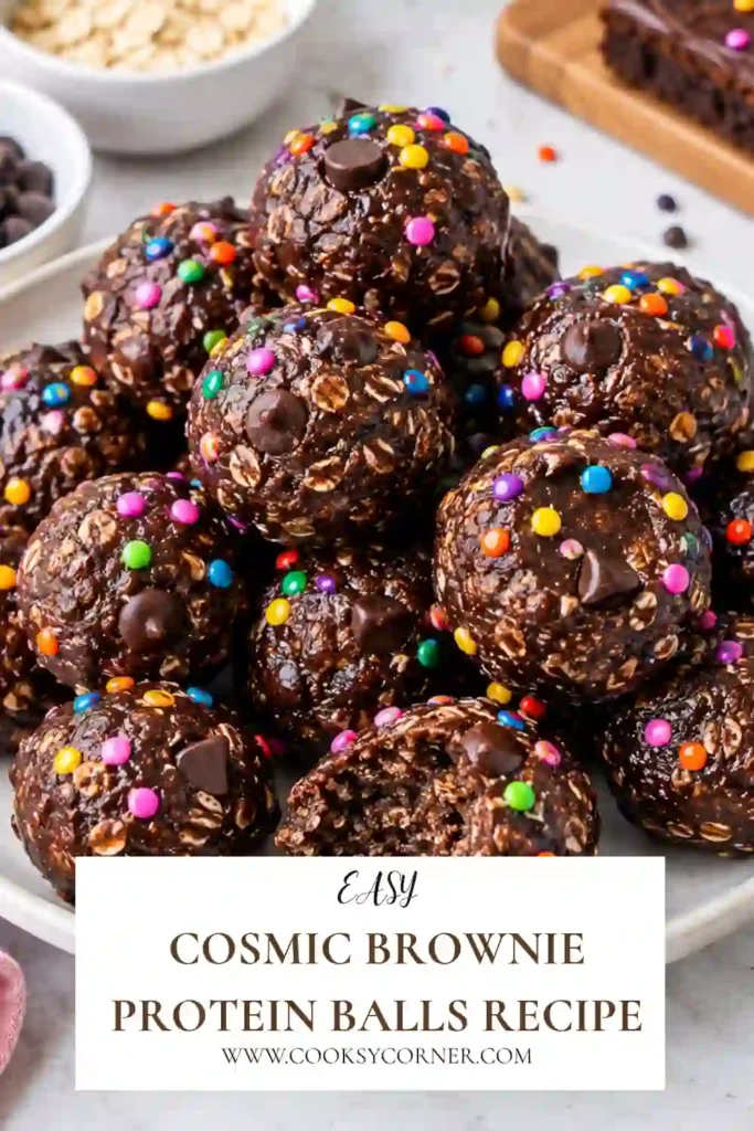 Healthy Cosmic Brownie Protein Balls with fudgy chocolate centers, a smooth chocolate coating, and colorful rainbow sprinkles. These no-bake protein bites are made with almond flour, cocoa, protein powder, and nut butter.