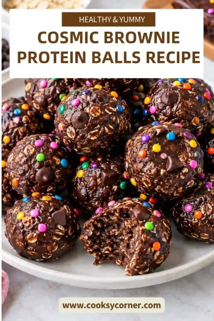 Healthy brownie protein balls arranged on parchment paper with a glossy chocolate shell and colorful sprinkles. Each no-bake bite has a rich, fudgy chocolate center.