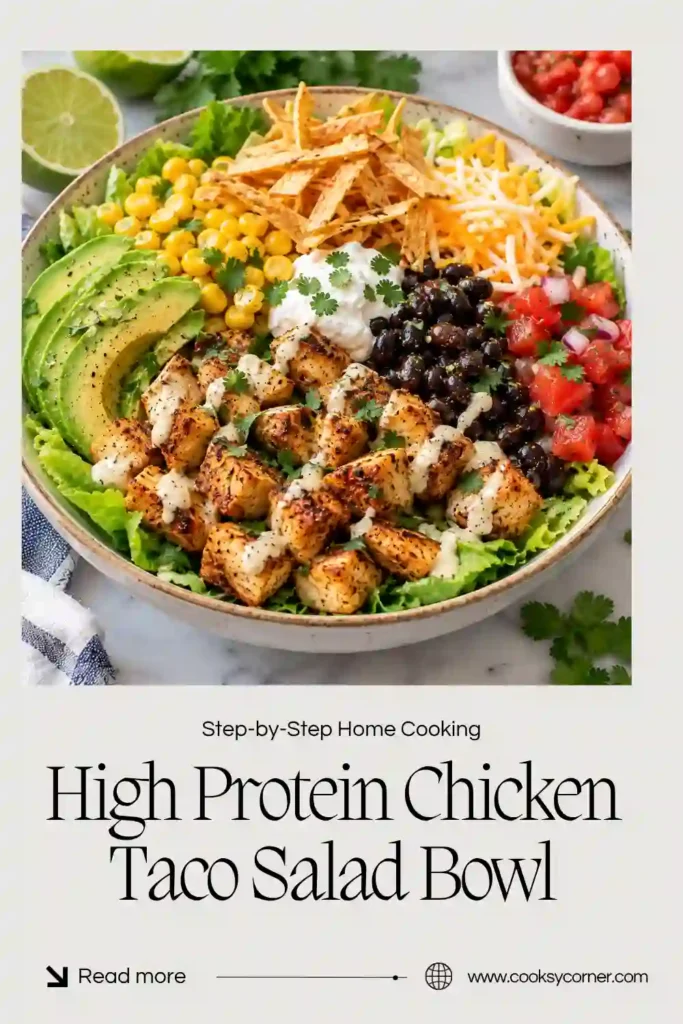 Close-up of a healthy chicken taco salad with tender sliced chicken breast, fresh lettuce, sweet corn, black beans, and juicy cherry tomatoes. A sprinkle of shredded cheese and fresh cilantro adds flavor and color.