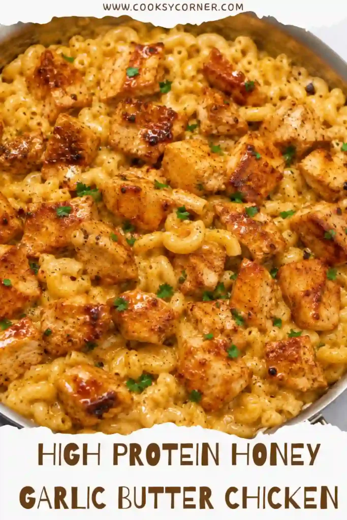 Close-up of honey garlic chicken with golden buttery glaze and creamy mac and cheese. The chicken is seasoned with smoked paprika and garlic and finished with chopped parsley.