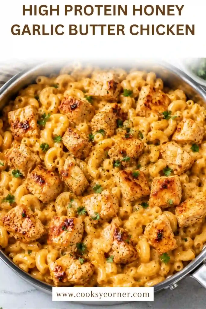 Homemade chicken mac and cheese with honey garlic butter chicken and fresh parsley. The creamy pasta and golden chicken create a rich, comforting meal-prep dinner.