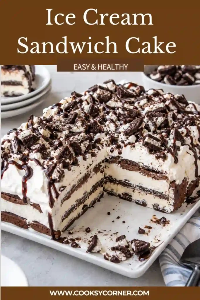 Ice Cream Sandwich Cake layered with vanilla ice cream sandwiches, fluffy whipped topping, chocolate fudge, caramel sauce, and chopped pecans. The frozen cake is sliced into creamy rectangular servings.