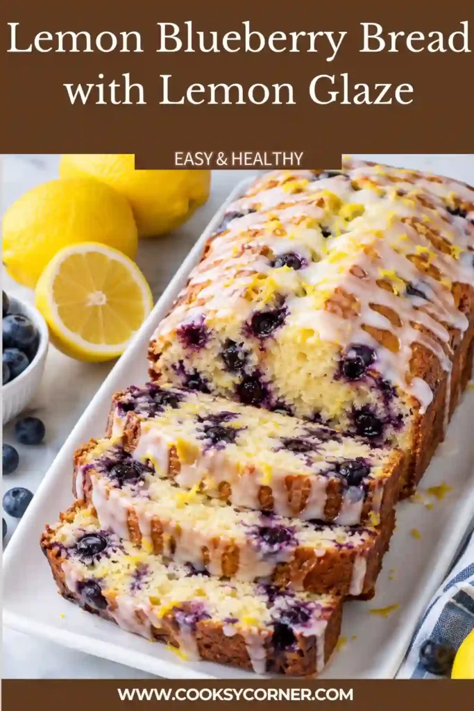 Blueberry bread with lemon glaze sliced on a serving board to show the tender fruit-filled center. The loaf is topped with bright citrus glaze and fresh blueberries.