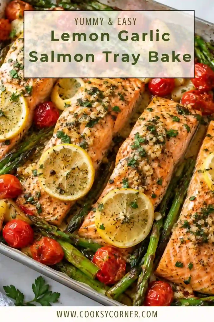 Baked salmon with asparagus and tomatoes coated in olive oil, lemon, garlic, and Dijon mustard. The salmon has a lightly golden surface with tender, flaky flesh.