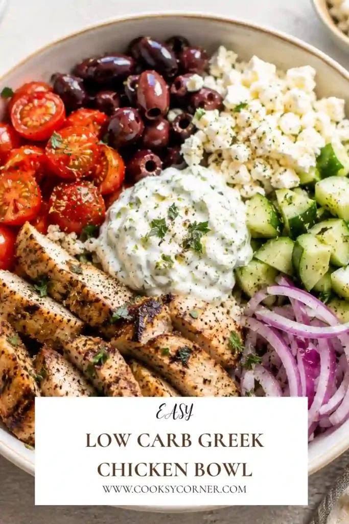Low Carb Greek Chicken Bowl with sliced grilled chicken served over seasoned cauliflower rice. Fresh cucumber, tomatoes, Kalamata olives, feta, tzatziki, and herbs complete the bowl.