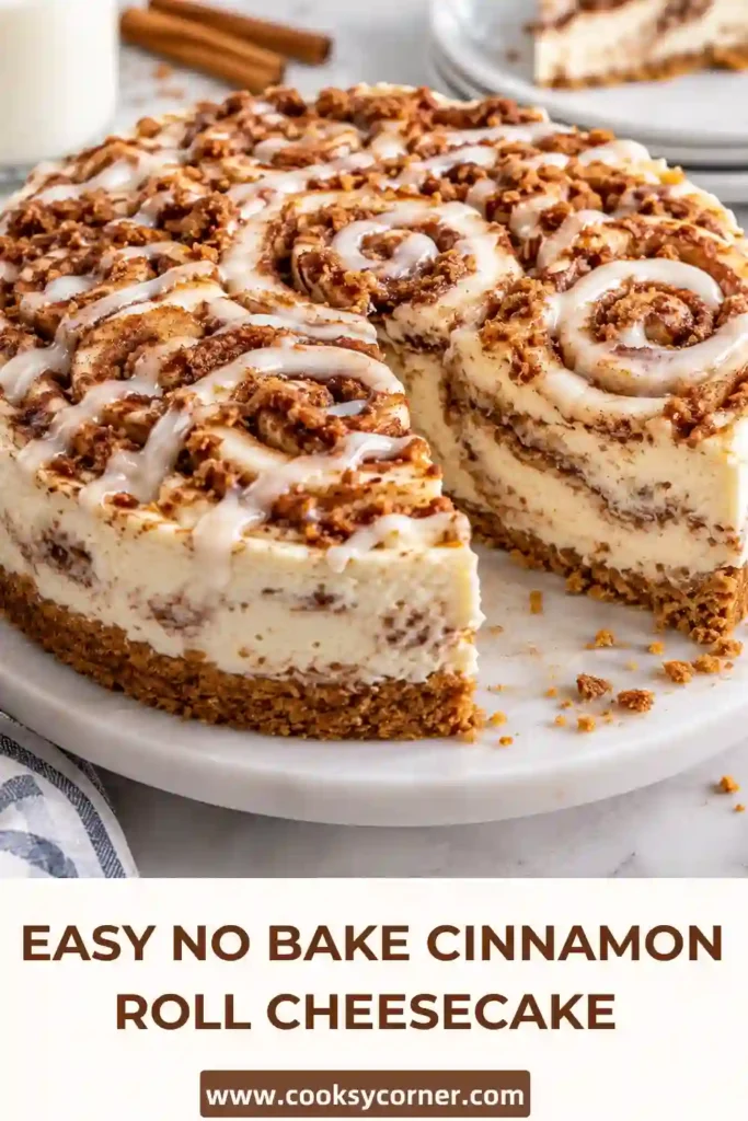 Creamy cinnamon roll cheesecake topped with piped whipped cream and rich caramel cinnamon swirls. The no bake cheesecake sits on a golden cookie crumb crust.