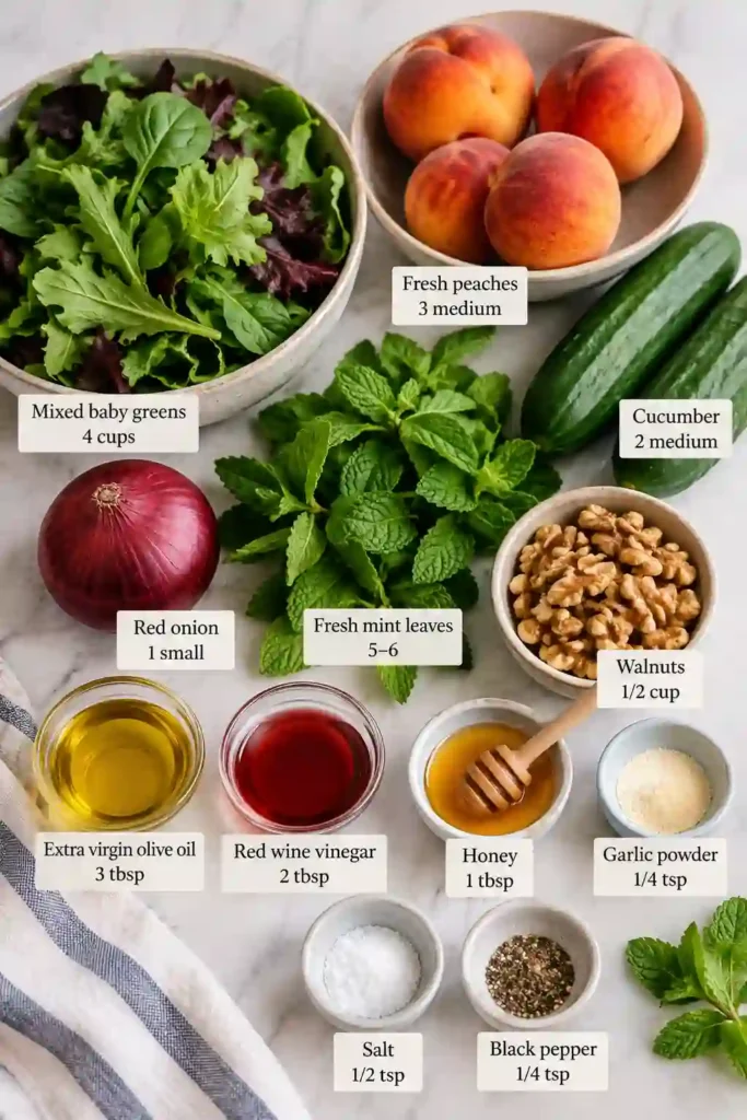 Fresh Peach Salad with walnuts and honey vinaigrette served over mixed baby greens. Juicy peaches, cucumber, mint, and red onion create a colorful summer salad.