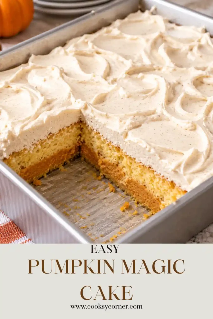 A square slice of Pumpkin Magic Cake on a white dessert plate showing soft yellow cake, creamy orange pumpkin filling, and fluffy vanilla frosting. The layered pumpkin cake has a light sprinkle of cinnamon on top.