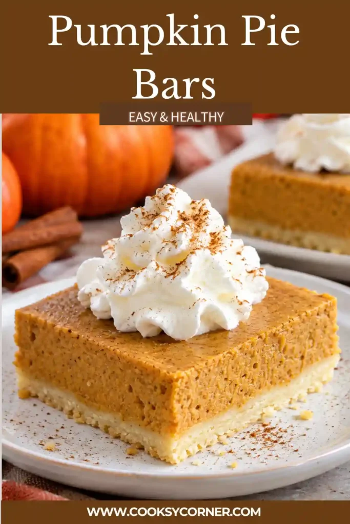 Close-up of a pumpkin pie bar showing smooth pumpkin custard and a thick, crumbly shortbread crust. The rich orange filling and buttery golden base create two distinct dessert layers.