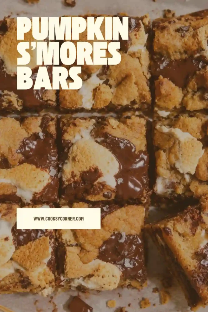 Freshly baked pumpkin cookie bars in a square baking pan with toasted marshmallows, melted chocolate, and golden cookie dough. The bars have a rustic topping with visible pockets of gooey marshmallow.