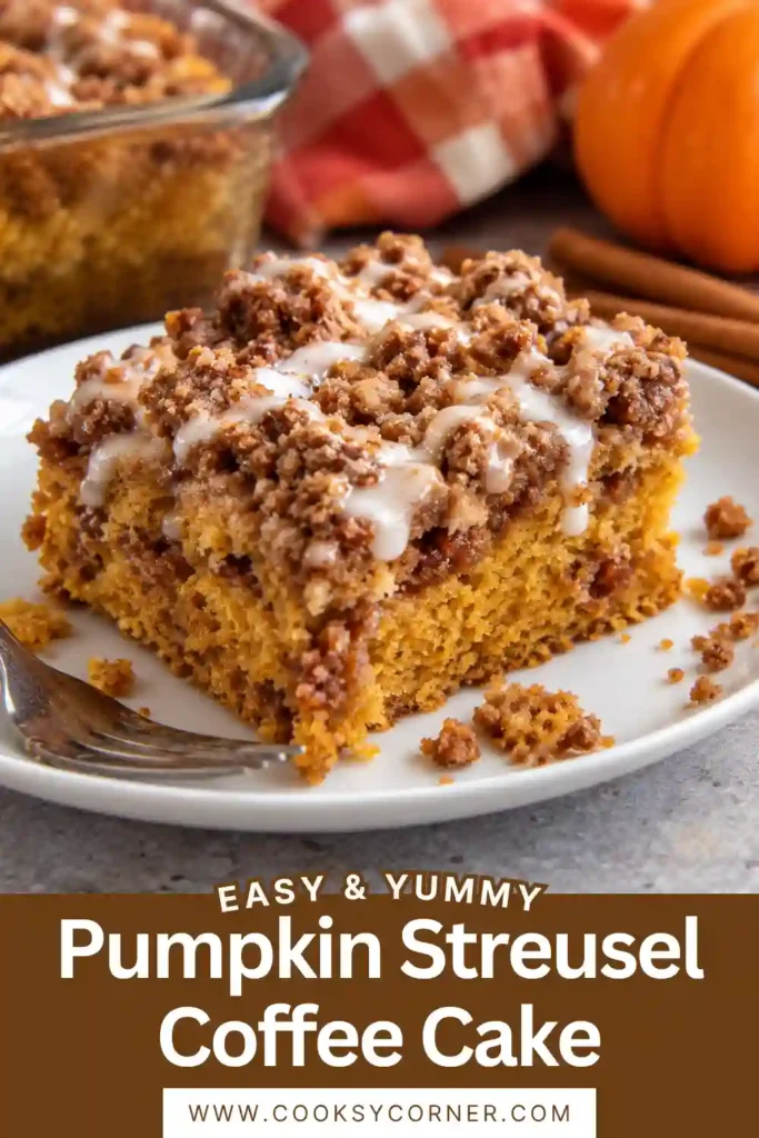 Close-up of pumpkin crumb cake showing its moist cinnamon-spiced interior and golden streusel topping. Chopped pecans and buttery brown sugar crumbs add a crunchy texture.
