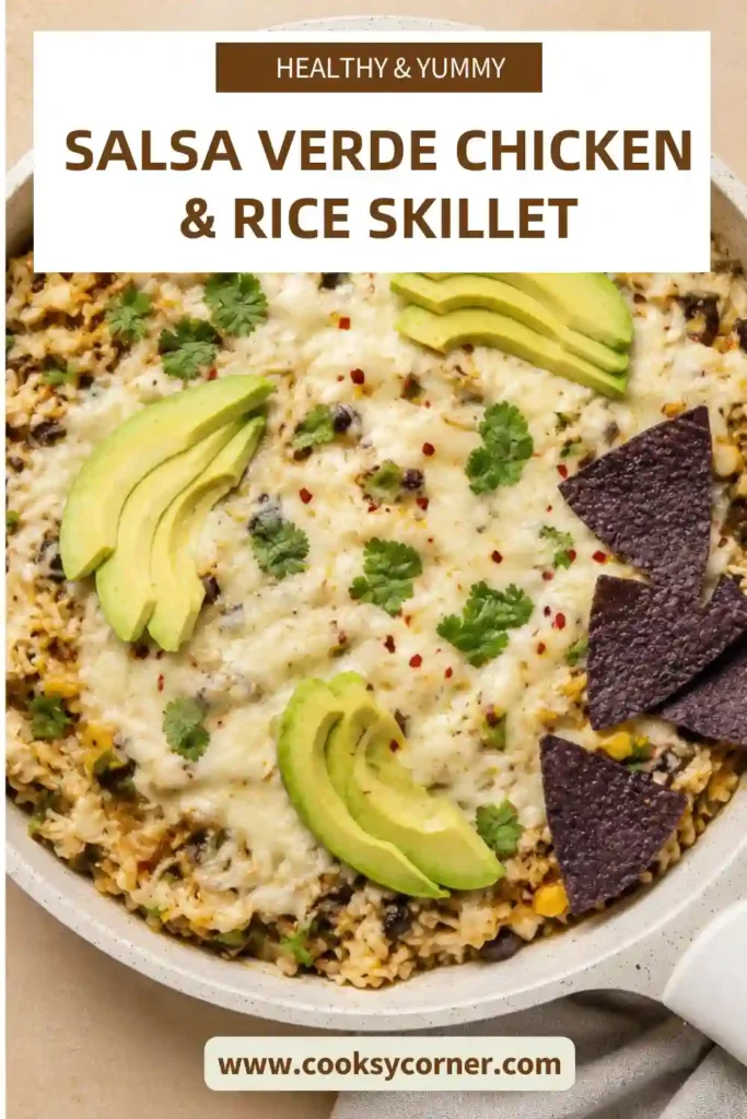 One-pan chicken and rice made with salsa verde, tender chicken, black beans, roasted corn, green chiles, and Monterey Jack cheese. The finished skillet is topped with cilantro and creamy avocado slices.