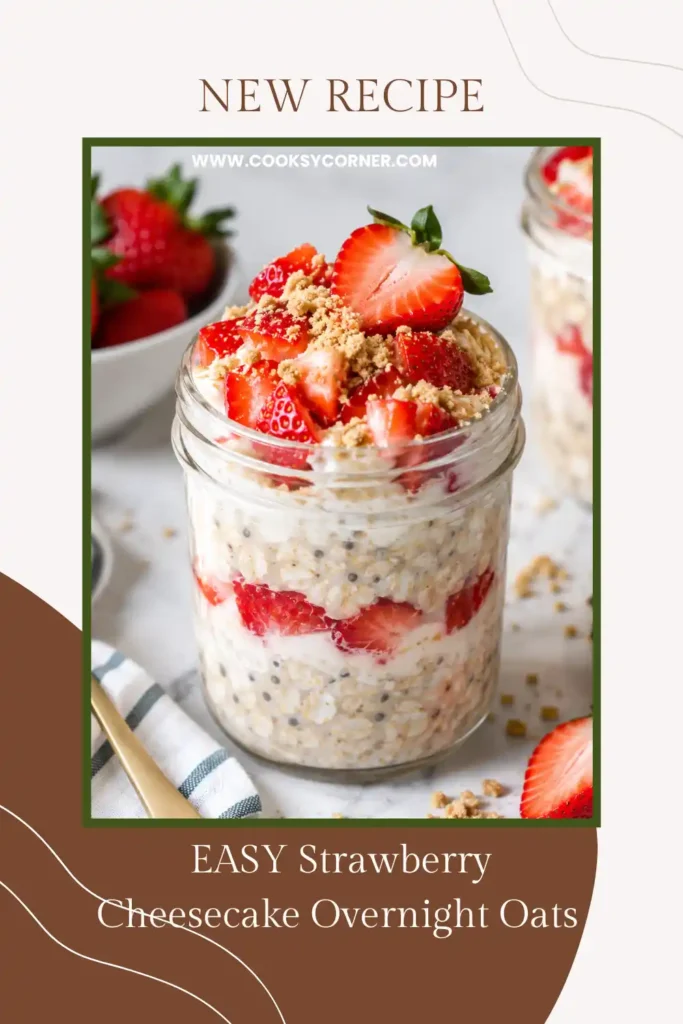 Strawberry Cheesecake Overnight Oats layered in a breakfast jar with fresh berries and crunchy graham cracker crumbs. The thick and creamy oats have a sweet, tangy cheesecake-inspired flavor.