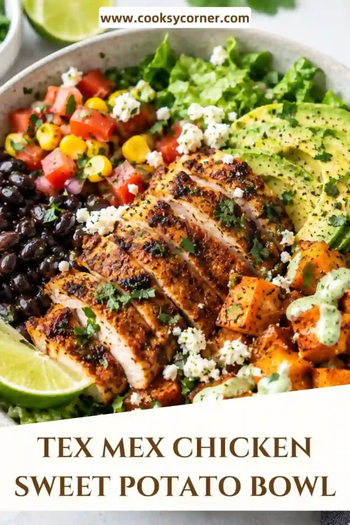 Chicken sweet potato bowl with smoky seasoned chicken, roasted sweet potato cubes, crisp romaine, black beans, corn, peppers, tomatoes, and shredded cheese. Fresh lime and creamy yogurt sauce add a bright finish.