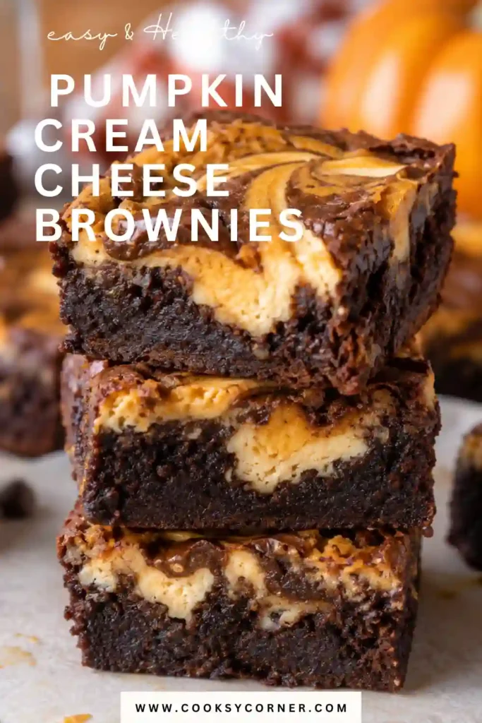 Pumpkin Cream Cheese Brownies sliced into rich chocolate squares with a creamy spiced pumpkin cheesecake center. A glossy chocolate ganache layer finishes this decadent fall dessert.