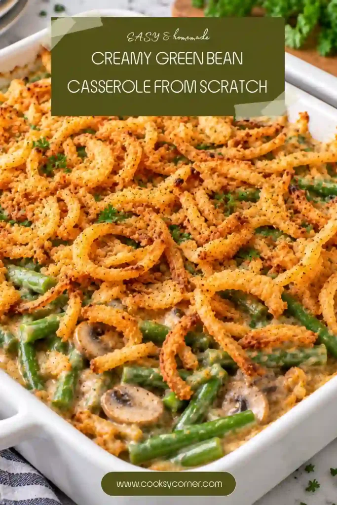 Homemade green bean casserole filled with fresh green beans and mushrooms in creamy garlic sauce. Golden breaded onions cover the top of the bubbling casserole.