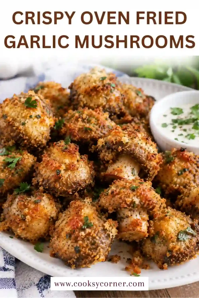 Crispy Oven Fried Garlic Mushrooms with a golden almond flour and sunflower seed coating. The baked mushrooms are seasoned with garlic, paprika, and parsley for a savory appetizer.
