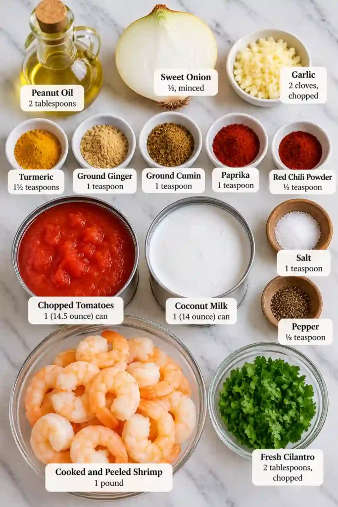 Homemade shrimp curry with coconut milk featuring tender shrimp in a rich tomato and coconut sauce. Turmeric, cumin, ginger, and chili create a warmly spiced Indian-inspired dish.